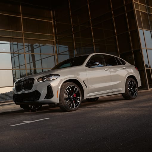 2025 BMW X4 driving down a city street