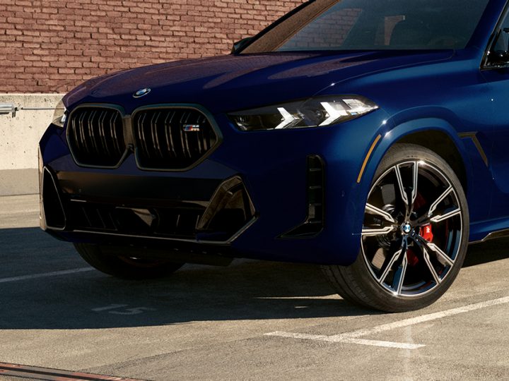 Detail of standard M Sport Brakes and available 22" wheels on a 2026 BMW X6 M60i