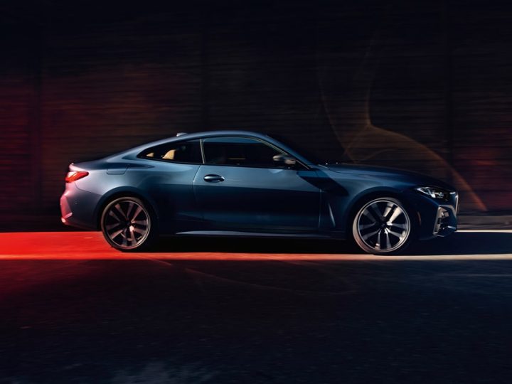 Side shot of the 2023 BMW M440i xDrive Coupe in a dramatic urban setting